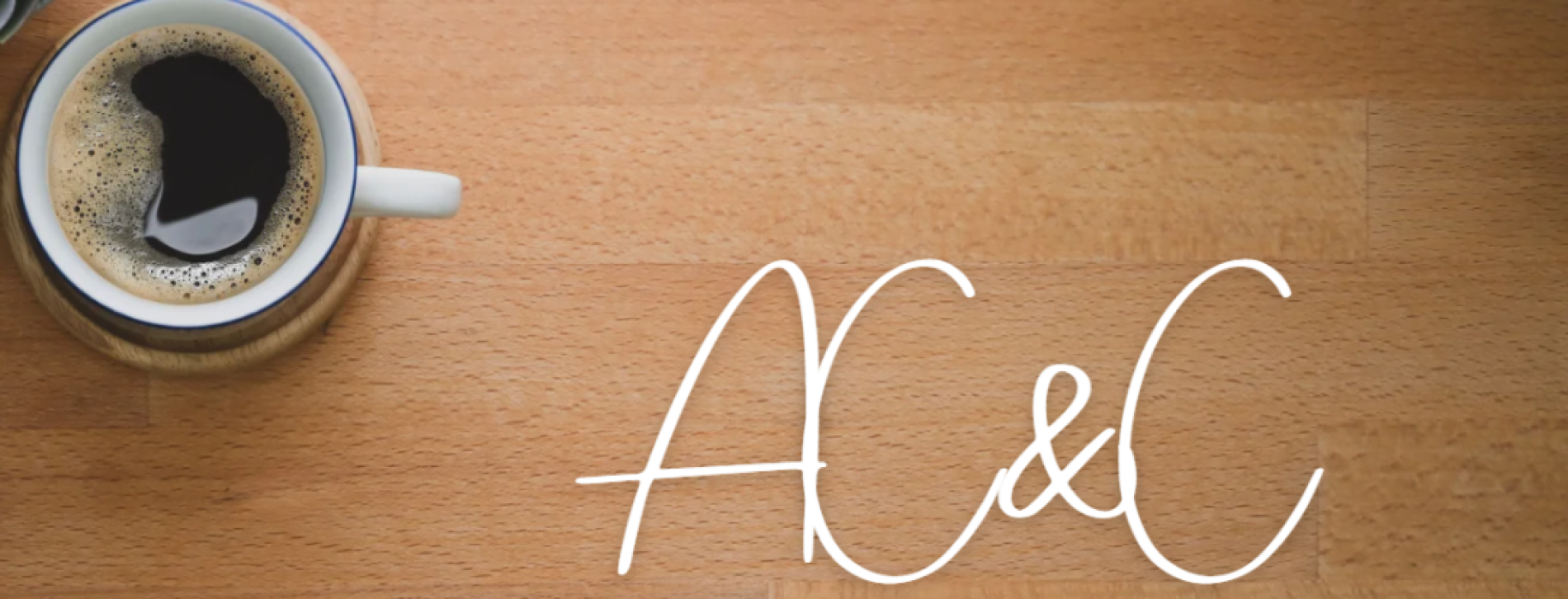 white cup filled with black coffee on a desk